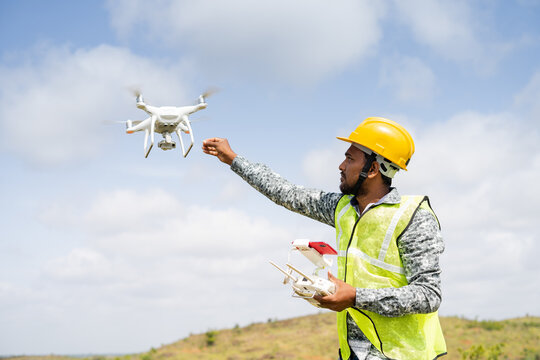 Drone operator flying a survey mission on site